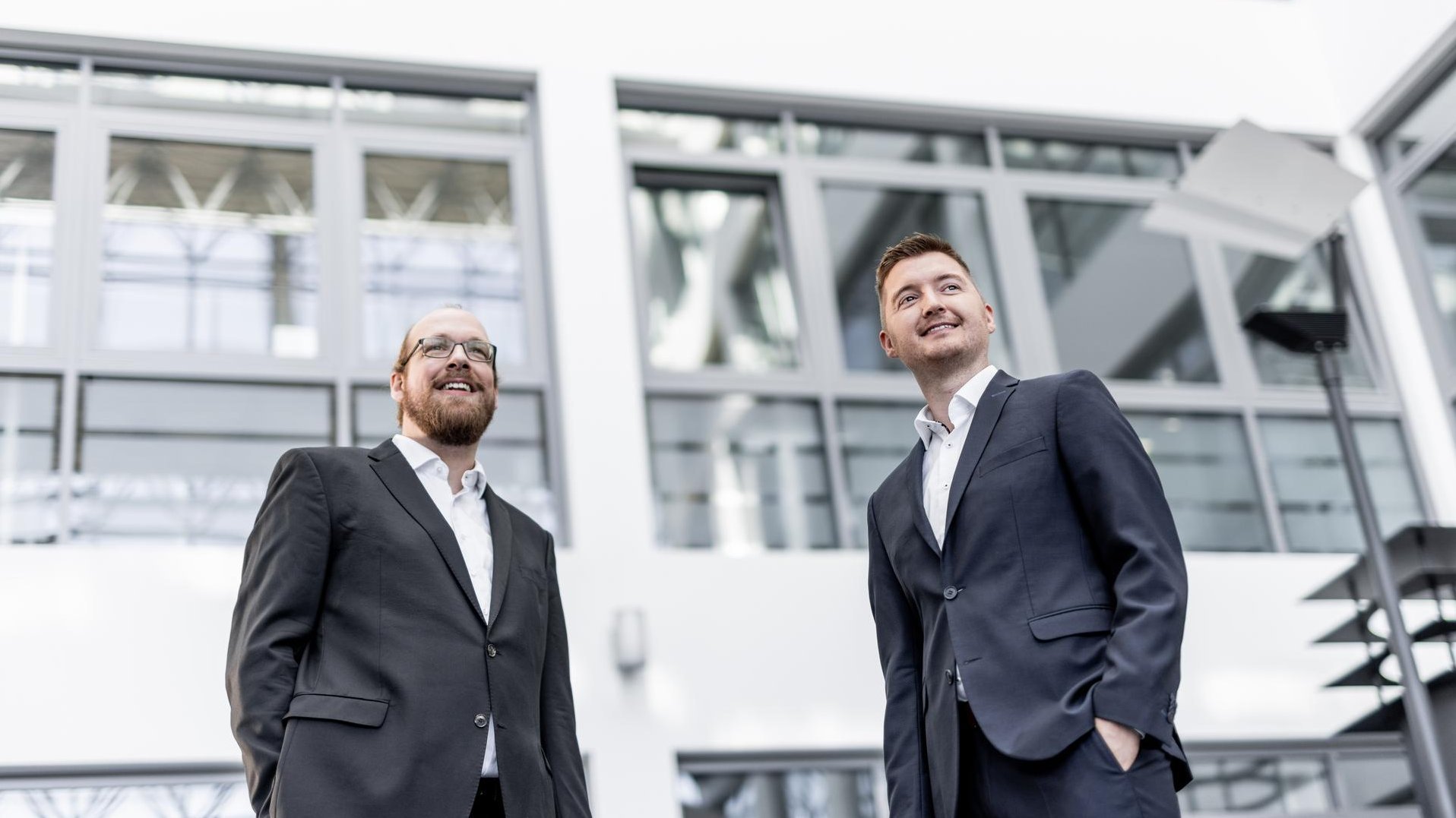 Two Hilscher employees looking at a tablet