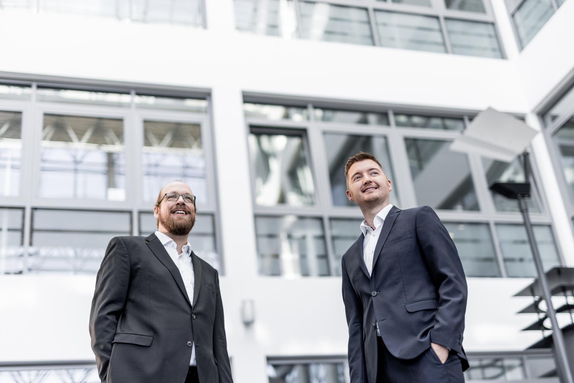 Two Hilscher employees looking at a tablet